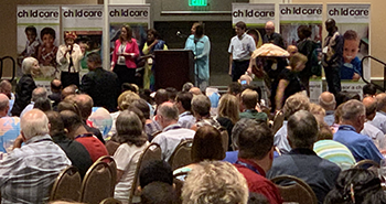 ICCM's Regional Coordinators stand on stage at the ICCM Dinner